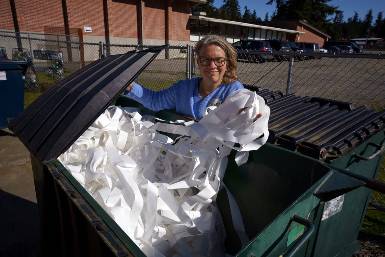Joan Green of rePurpose sifts through the dumpster at the South Whidbey Community Center in search of reusable materials. (File photo by David Welton)