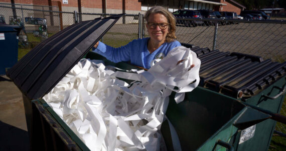 File photo by David Welton
Joan Green of rePurpose sifts through some garbage at the South Whidbey Community Center.