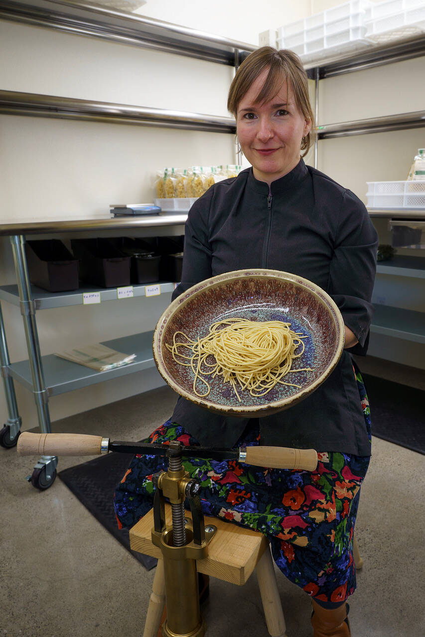 Echo holds a ceramic bowl with her fresh pasta. She will sell pasta bowls created by local artists, as well as pasta rollers, pasta machines and Italian flour. (Photo by David Welton)
