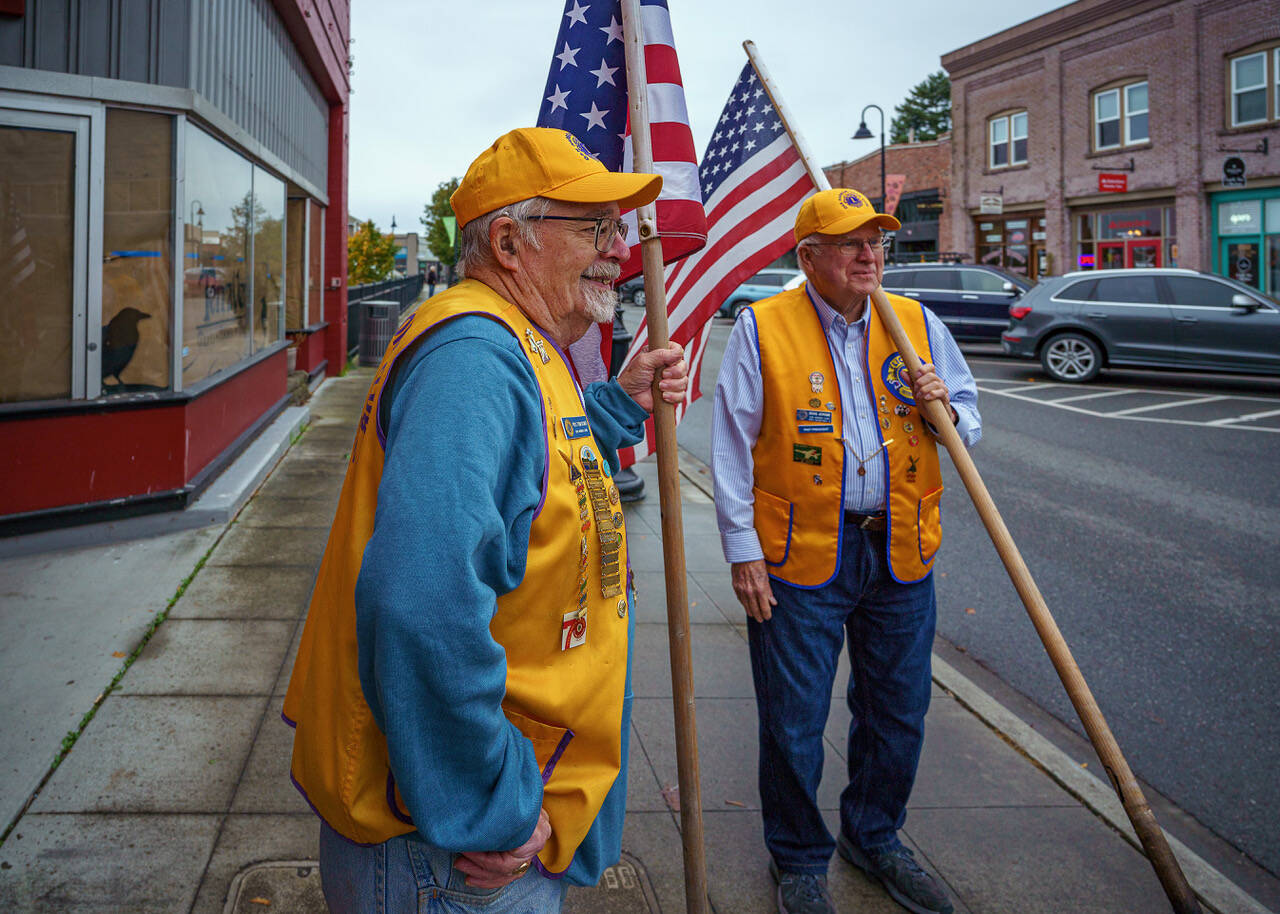 Doug Jerome and Tom Bond look for holes to plant their flags on Pioneer Way. (Photo by David Welton)