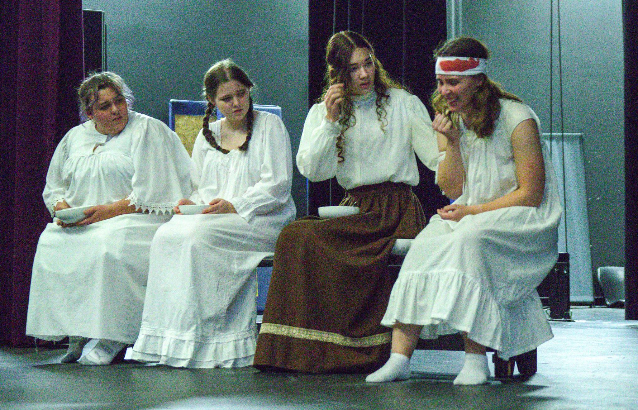 Students Linndsy Scheer, Piper Earhart, Adriana Froman and Savannah Dickinson during a scene of “Nellie.” (Photo by Luisa Loi)