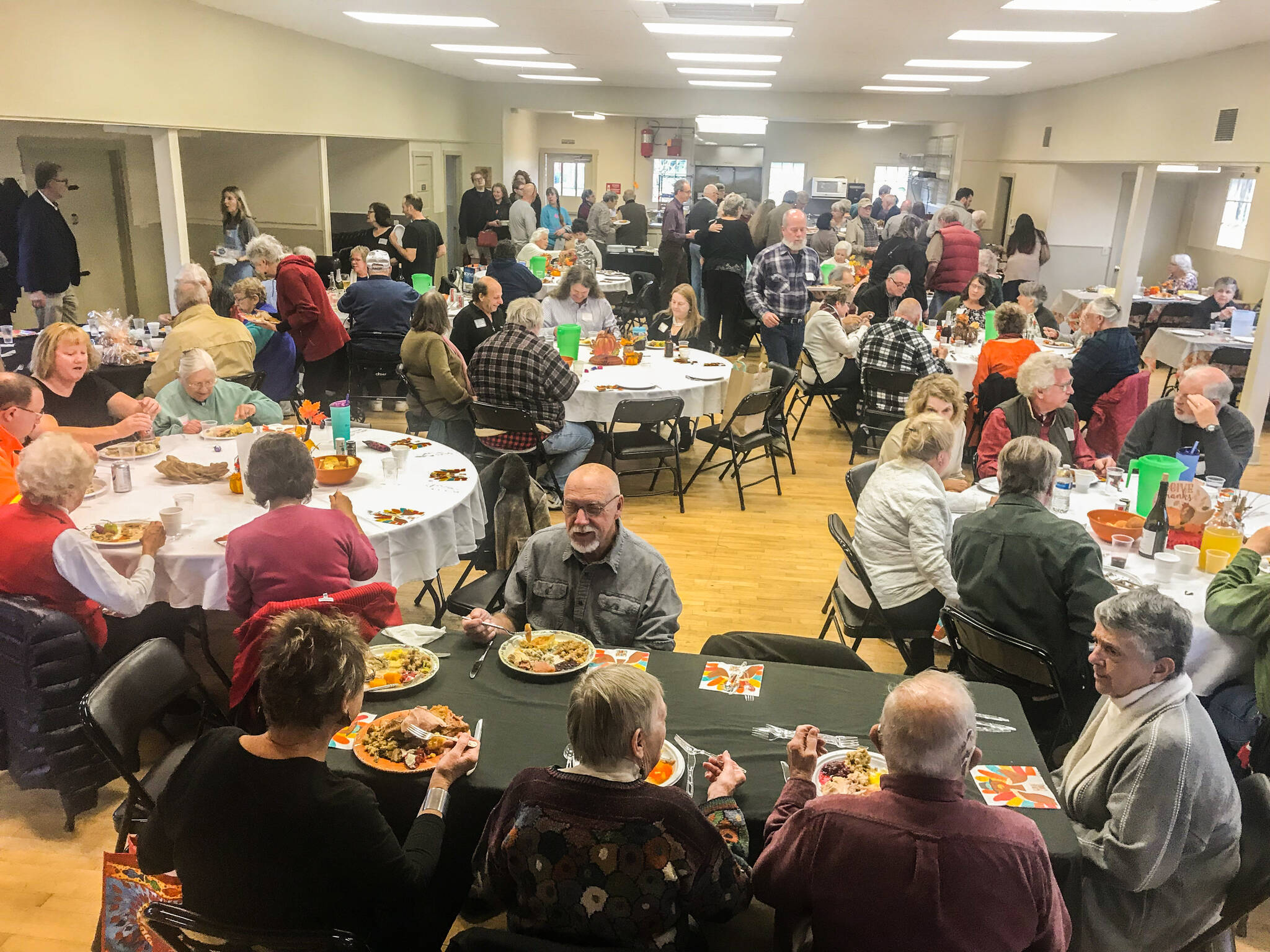 Residents feast and socialize at the community potluck at the Coupeville Rec Hall. (Photo provided)
