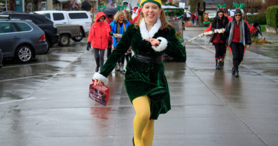 An elf skips down the streets of Langley during a previous year’s Holly Jolly Parade. (Photo by David Welton)