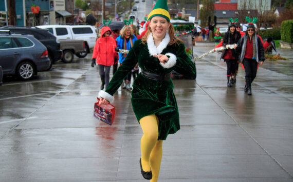 An elf skips down the streets of Langley during a previous year’s Holly Jolly Parade. (Photo by David Welton)
