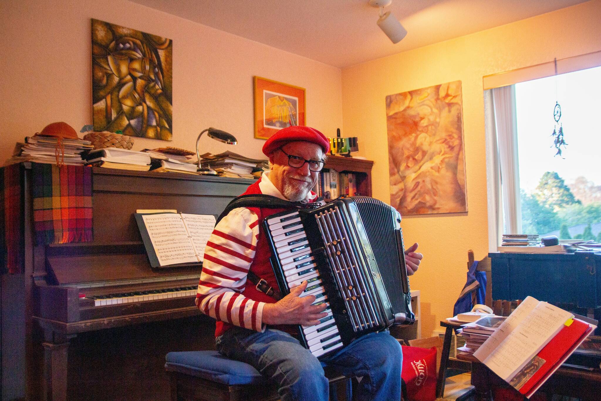 David Locke plays the accordion at his house in Langley. One of the most common compliments he hears is that his performances feel like Paris. (Photo by Luisa Loi)