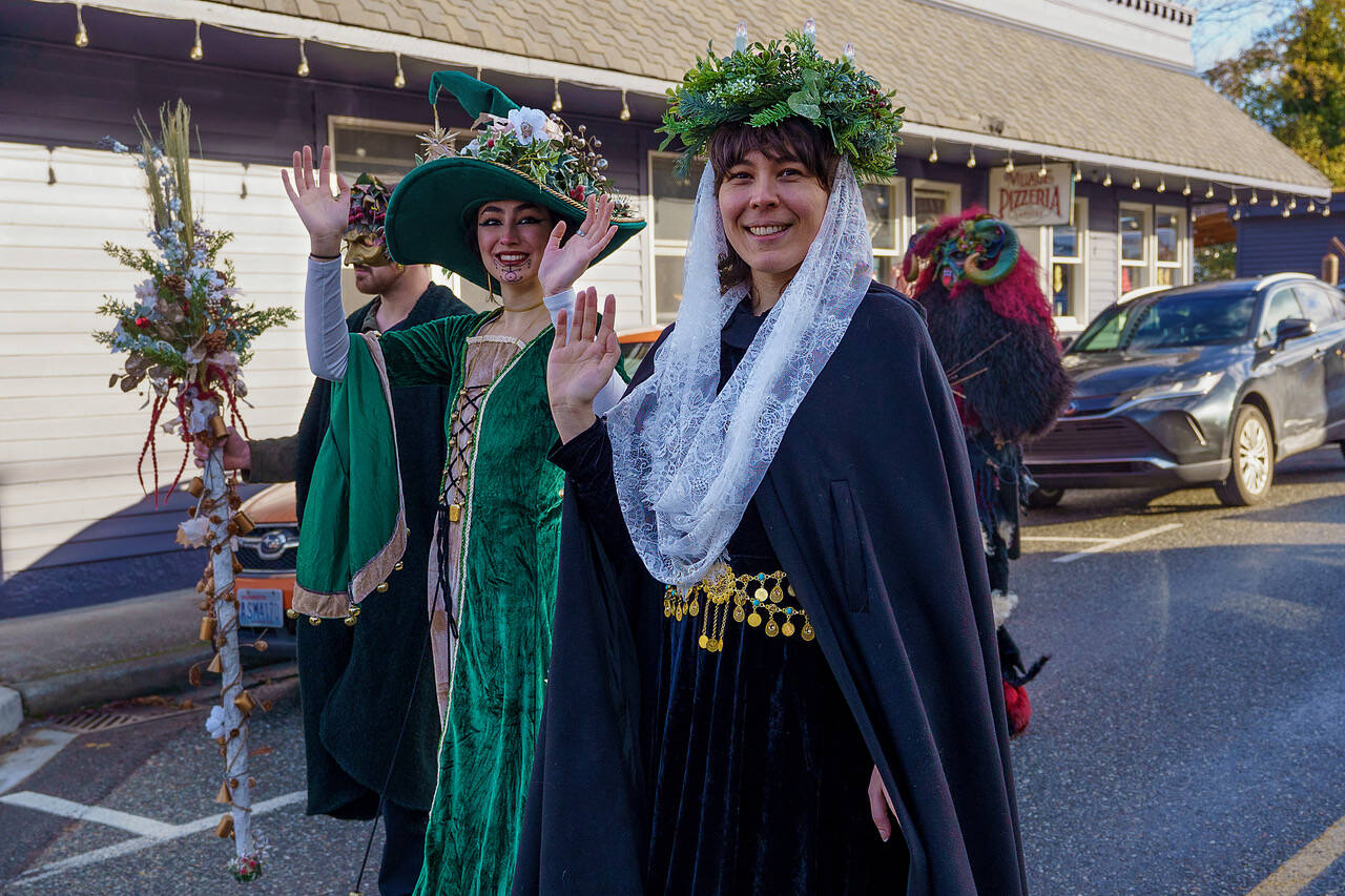People wore creative costumes of all kinds to the parade. From left, Jackson Alford as the Holly King, Bijan Mitchell as the Yule Witch and Katie Goudey as Santa Lucia. (Photo by David Welton)