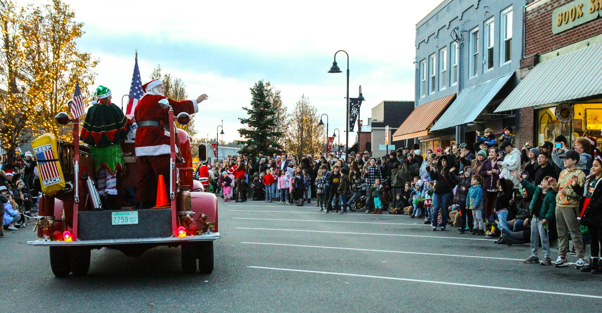 A large crowd cheered as Santa arrived at Dock & Pioneer on board of a shiny red truck. (Photo by Luisa Loi)