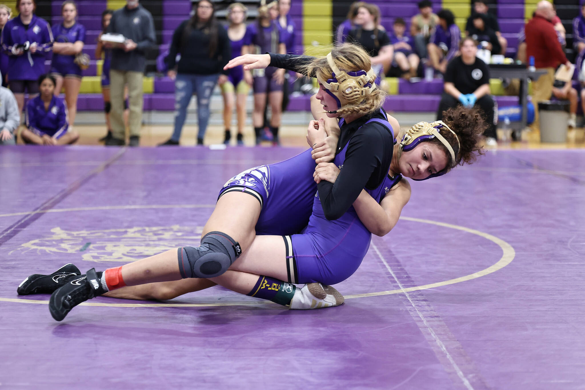 Oak Harbor wrestlers Carla Turner and Genesis Egli compete during the Purple and Gold event Thursday night at Oak Harbor High School’s gym. (Photo by John Fisken)
