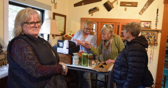 Whidbey Vintage Collective co-owners Heidi Norris (left) and Leslie Jackson ring up purchases of Karen Heeney and Lori Sanford. The Freeland store opened in November.
Photo by Patricia Guthrie
