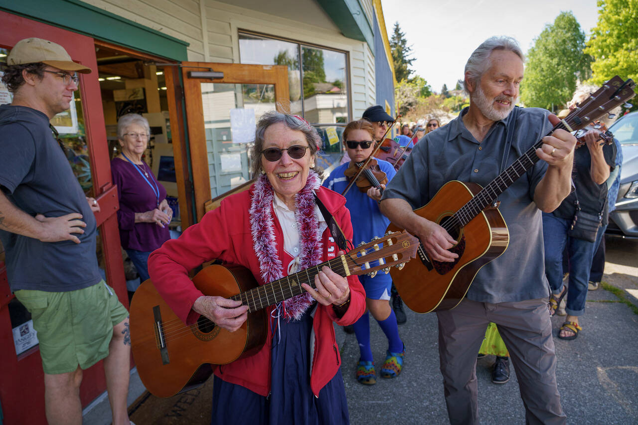 Linda Good and Karl Olsen, minister of music at Trinity Lutheran Church in Freeland, lead a farewell parade in song on May 20. (Photo by David Welton)