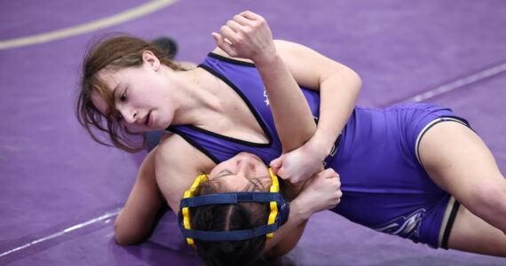 Photo by John Fisken
Oak Harbor’s Julia Gonzales tries to pin an opponent during a match Saturday during the Rock Island Rumble tournament Saturday that saw 13 schools compete at Oak Harbor High School. Gonzales placed first in the 100-pound weight class.