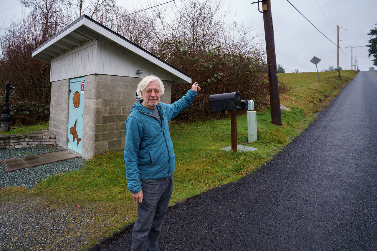John Lovie stands next to a wellhead, which might face seawater intrusion in the future. (Photo by David Welton)