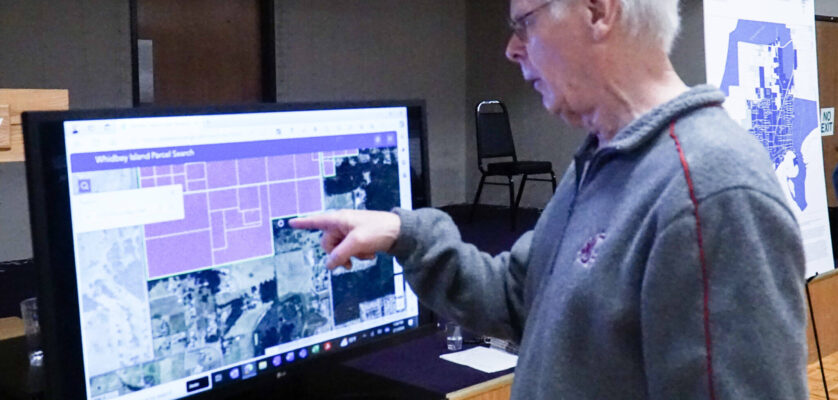 Oak Harbor resident Dennis Kjargaard points to his property at the PFAS public meeting on Thursday, which is 30 feet from the original PFAS sampling area. (Photo by Sam Fletcher)