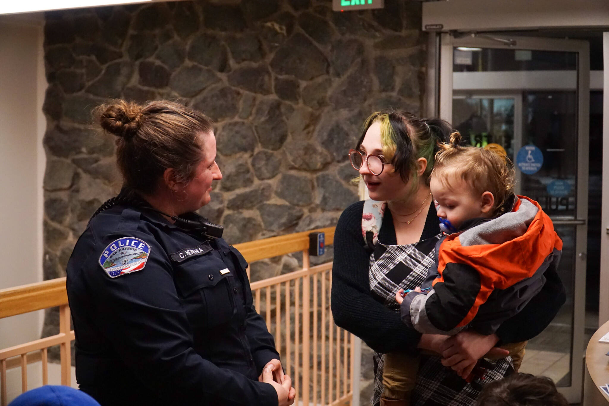 Officer Claire Herrera (left) talks with Asia James (middle), mother of William Belanger (right), whom Herrera saved, on Monday. (Photo by Sam Fletcher)