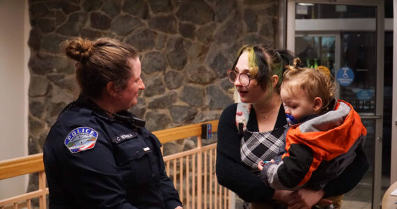 Officer Claire Herrera (left) talks with Asia James (middle), mother of William Belanger (right), whom Herrera saved, on Monday. (Photo by Sam Fletcher)