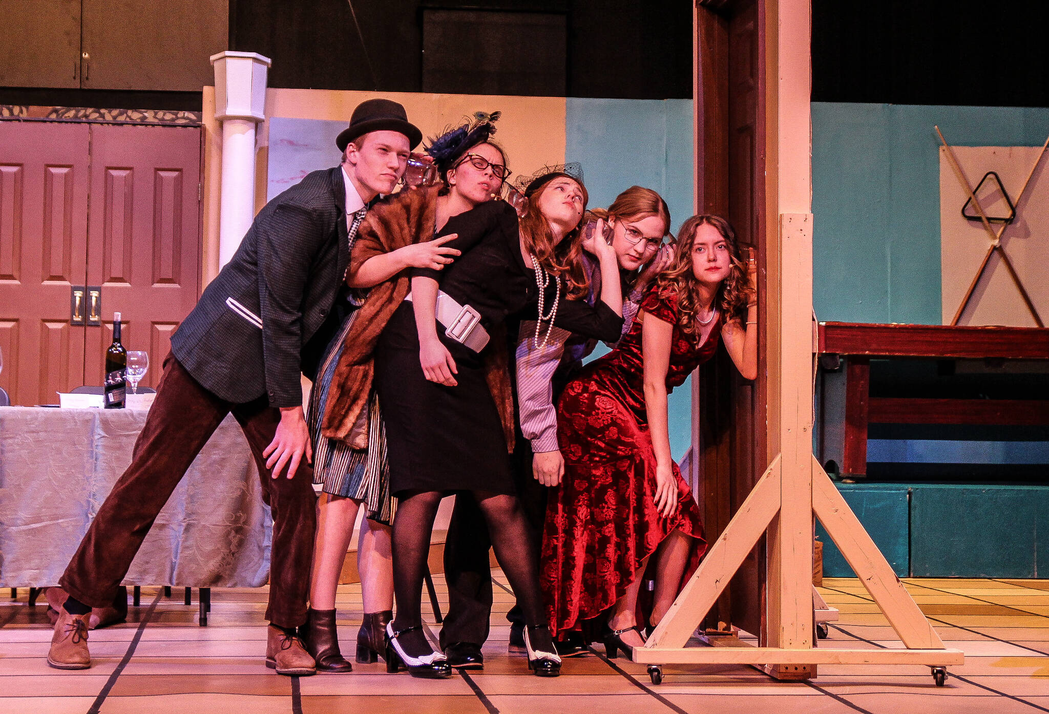 Mr. Green (Asher Lemme), Mrs. Peacock (Savannah Dickson), Mrs. White (Sadie Marriott), Professor Plum (Kincaid Cochran) and Miss Scarlet (Isabella Barbee) in a scene of Clue. At the beginning of the story, each character is assigned a fake name to keep their anonymity. (Photo by Luisa Loi)