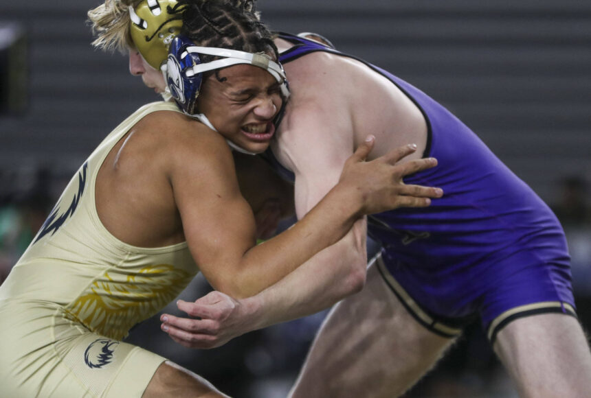 <p>Arlington’s Tre Haines and Oak Harbor’s Percie Hatfield wrestle during the 3A boys 157-pound championship match during Mat Classic XXXV on Saturday, Feb. 17, 2024, at the Tacoma Dome in Tacoma. (Annie Barker / The Herald)</p>