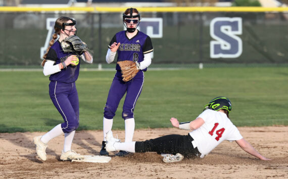Photo by John Fisken
Shortstop Haylee Burleigh helps get a Cascade runner out during a game March 12 at Oak Harbor High School. Also helping is Mia Regan.