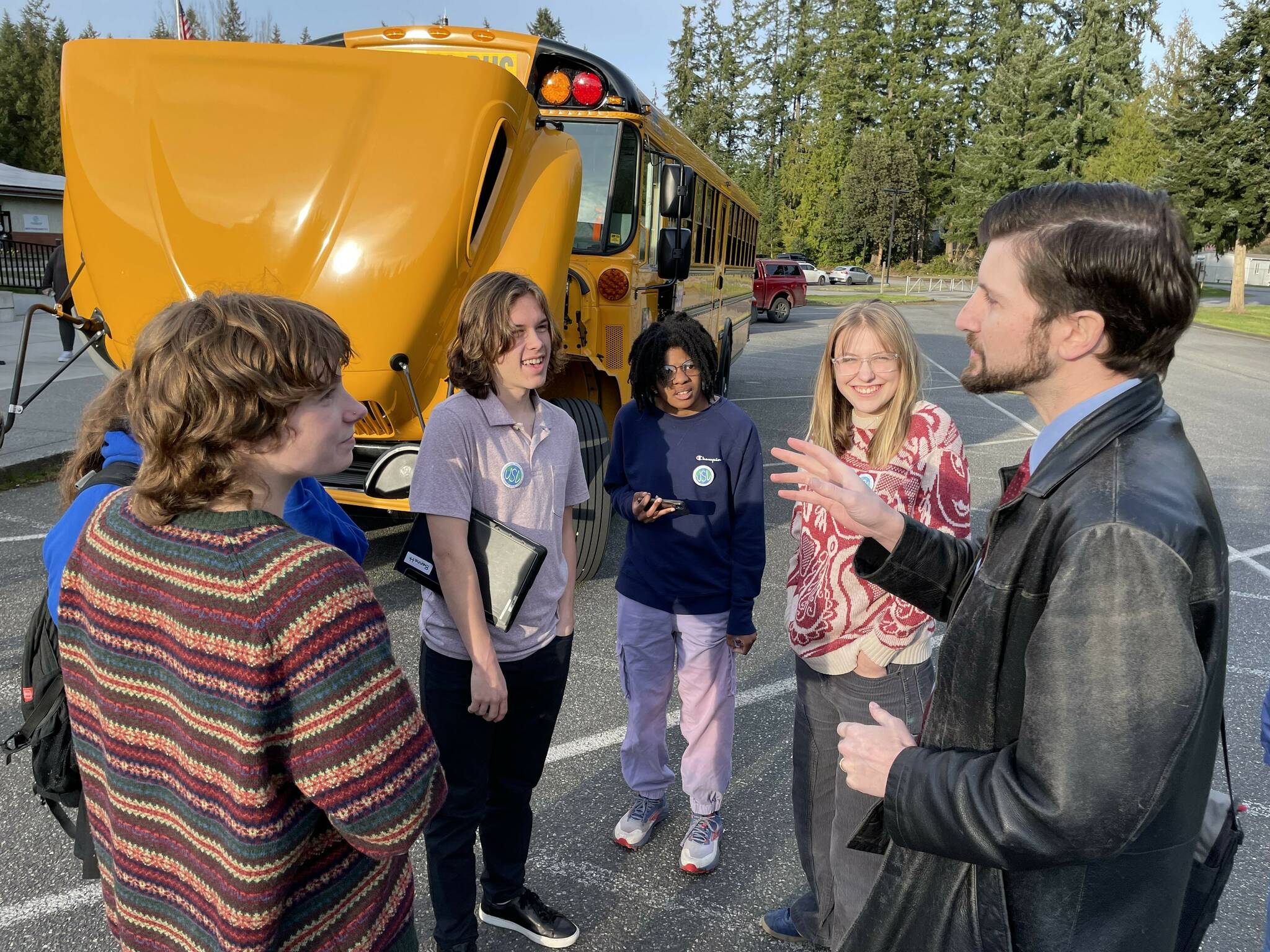 United Student Leaders talk with South Whidbey School District Board President Brook Willeford about the new bus. (Photo provided)