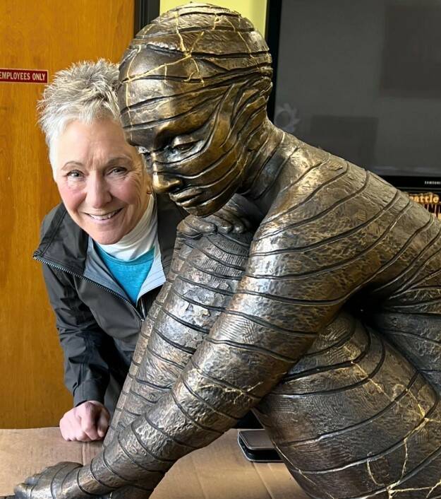 Photo provided
Maria Wickwire poses with the new Anillos, a bronze reproduction of her original ceramic sculpture. The gold lines, inspired by the Japanese tradition known as kintsugi, show where the original piece broke.