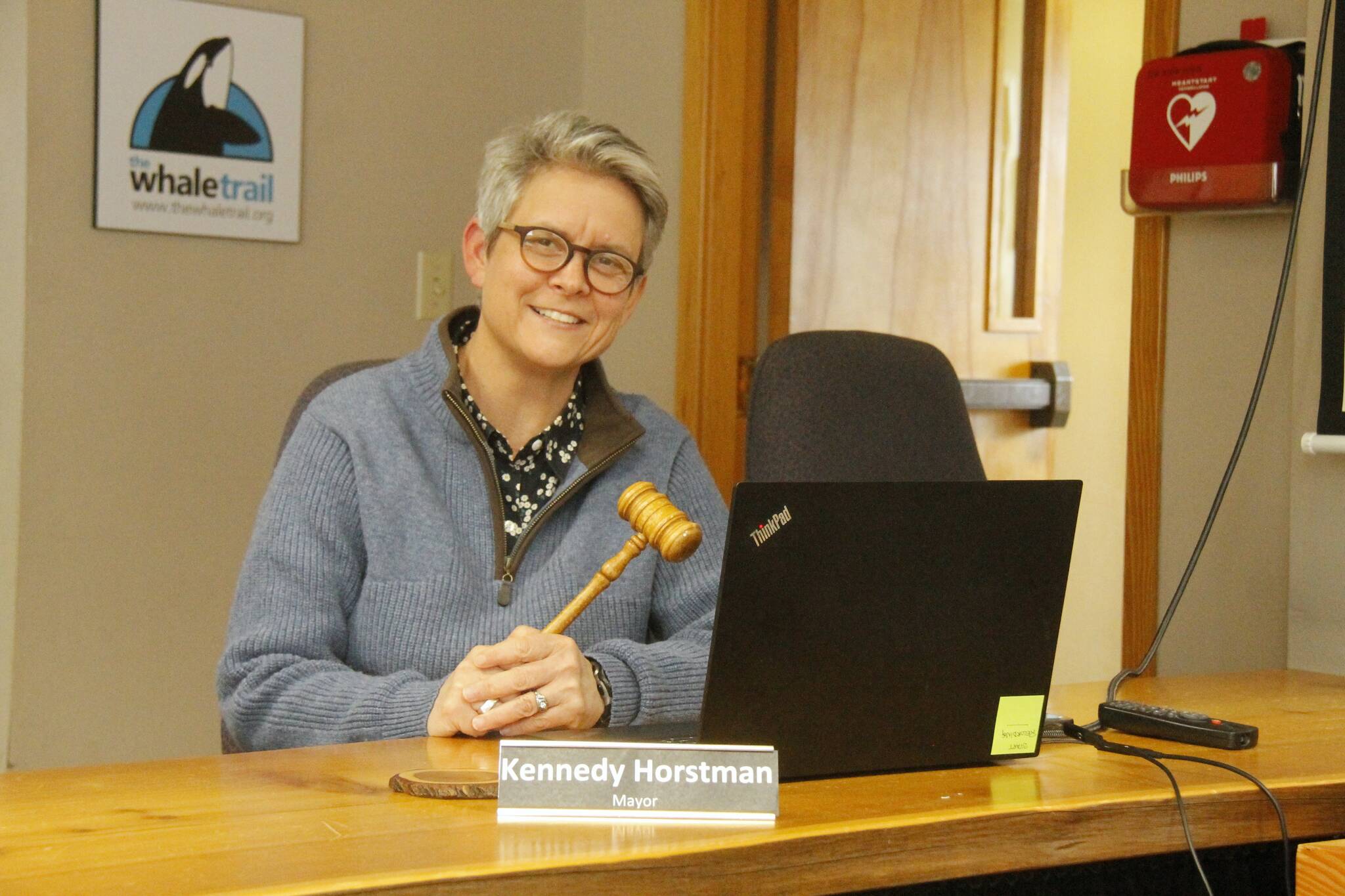 Mayor Kennedy Horstman tests out her gavel in empty city council chambers while setting up a Zoom meeting for a citizen-led committee on Wednesday. (Photo by Kira Erickson/South Whidbey Record)