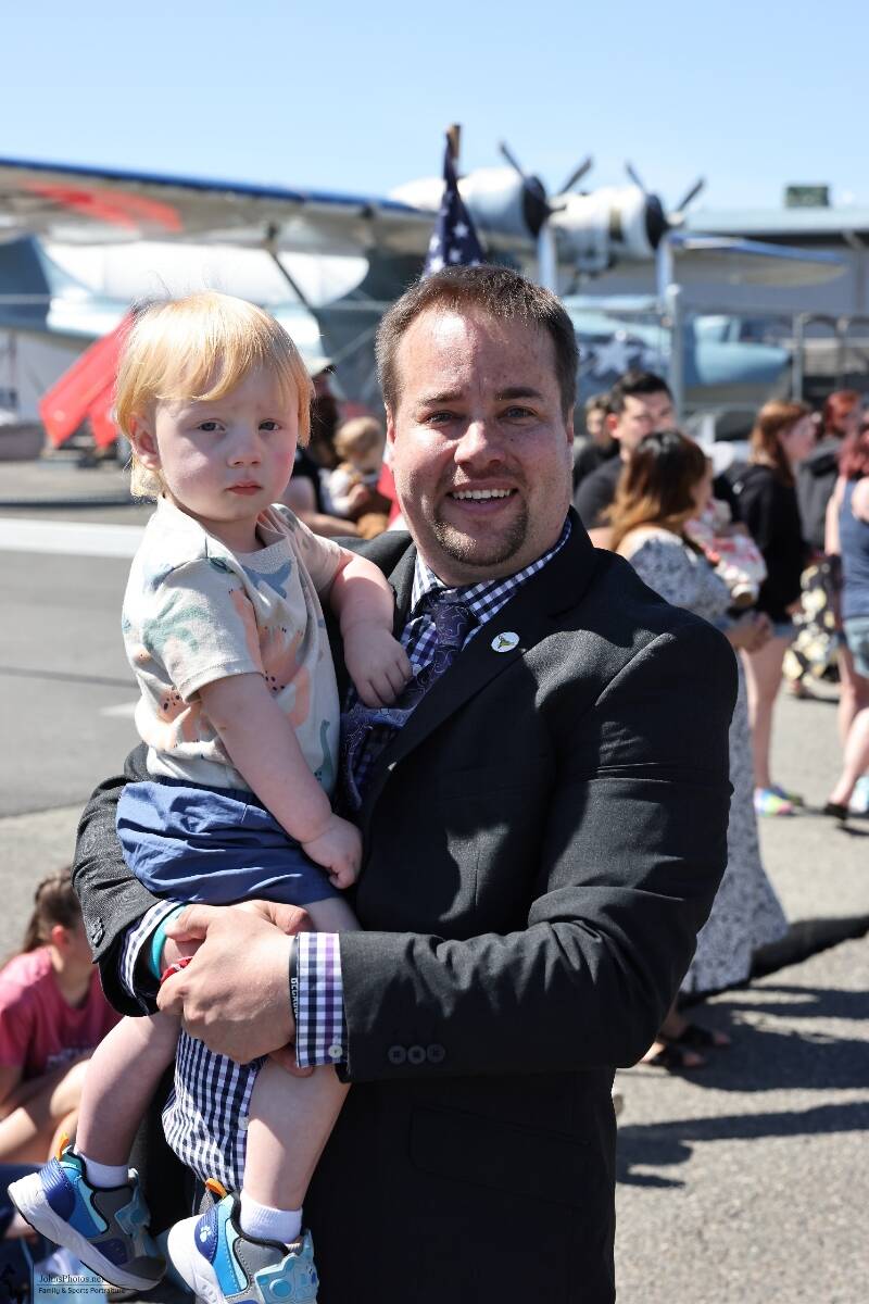 Shane Hoffmire hold his son.