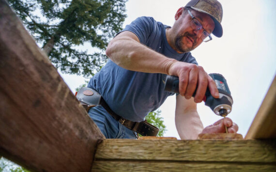 Photo by David Welton
A Hearts & Hammers volunteer repairs a deck on Saturday.