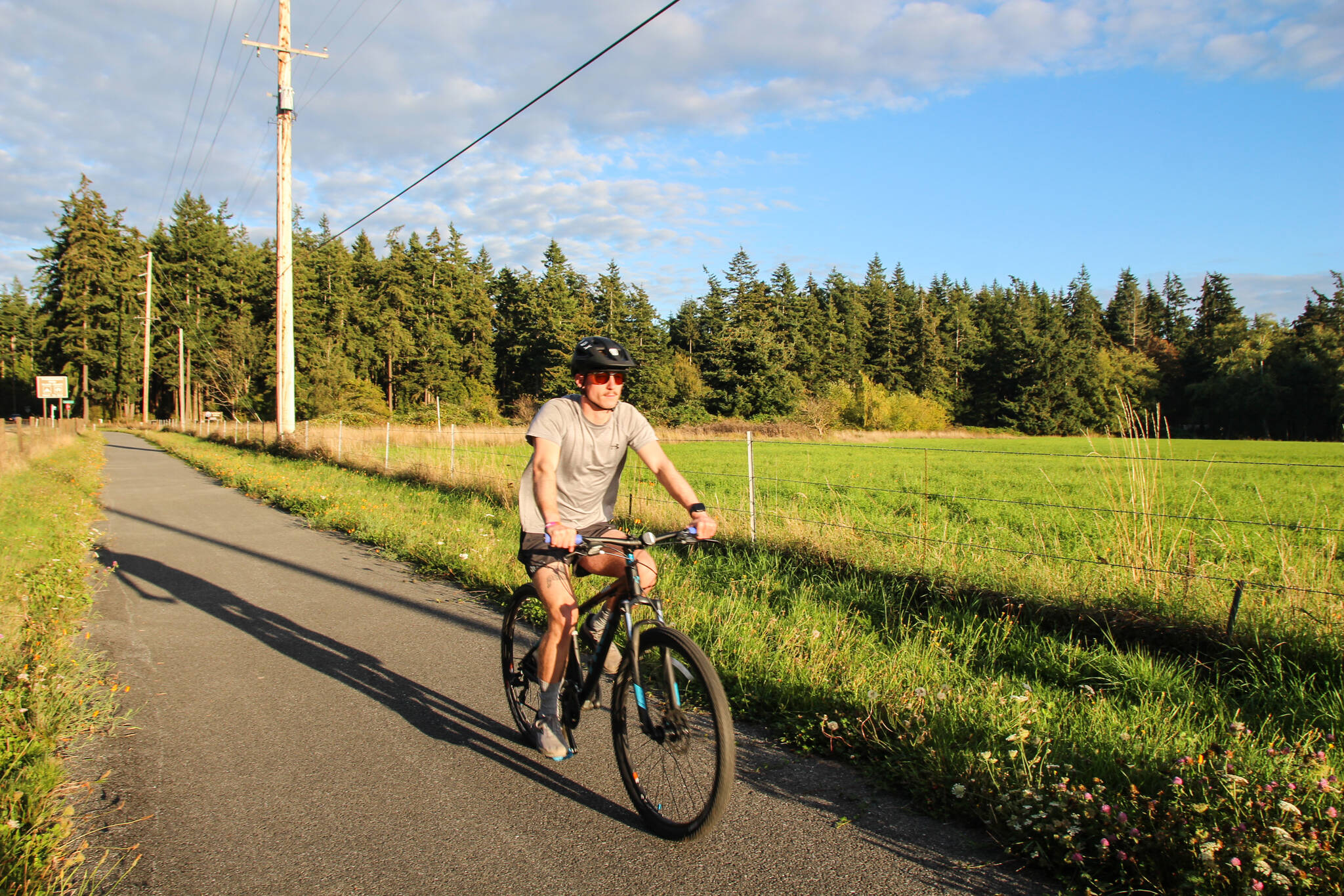 Oak Harbor resident Patrick Hanlon rides a bike on the Rhododendron Trail near Coupeville. (Photo by Luisa Loi)