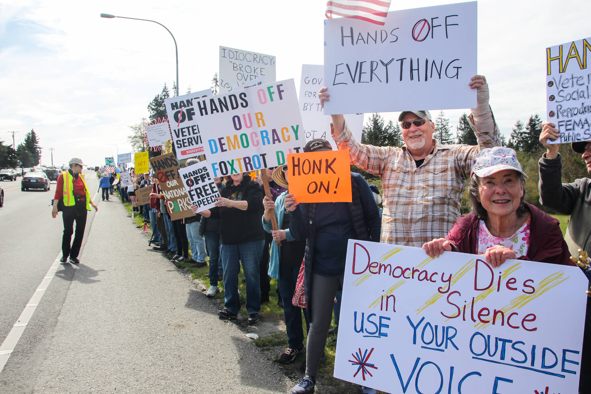 (Photo by Luisa Loi)
About 1,500 people showed up Saturday in front of Oak Harbor’s Navy aircraft monument, according to Indivisible Whidbey. Hundreds also rallied in Coupeville and Langley, joining a nationwide day of protest against the Trump administration.
