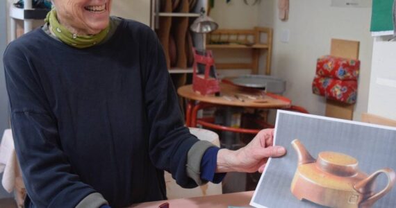 (Photo by Patricia Guthrie)
Artist Robbie Lobell looks over some of her ceramic designs for the Cook on Clay business she and Maryon Attwood founded 15 years ago. The company is now based in Ohio with new owners; Lobell and Atwood will continue to live and create in Langley.