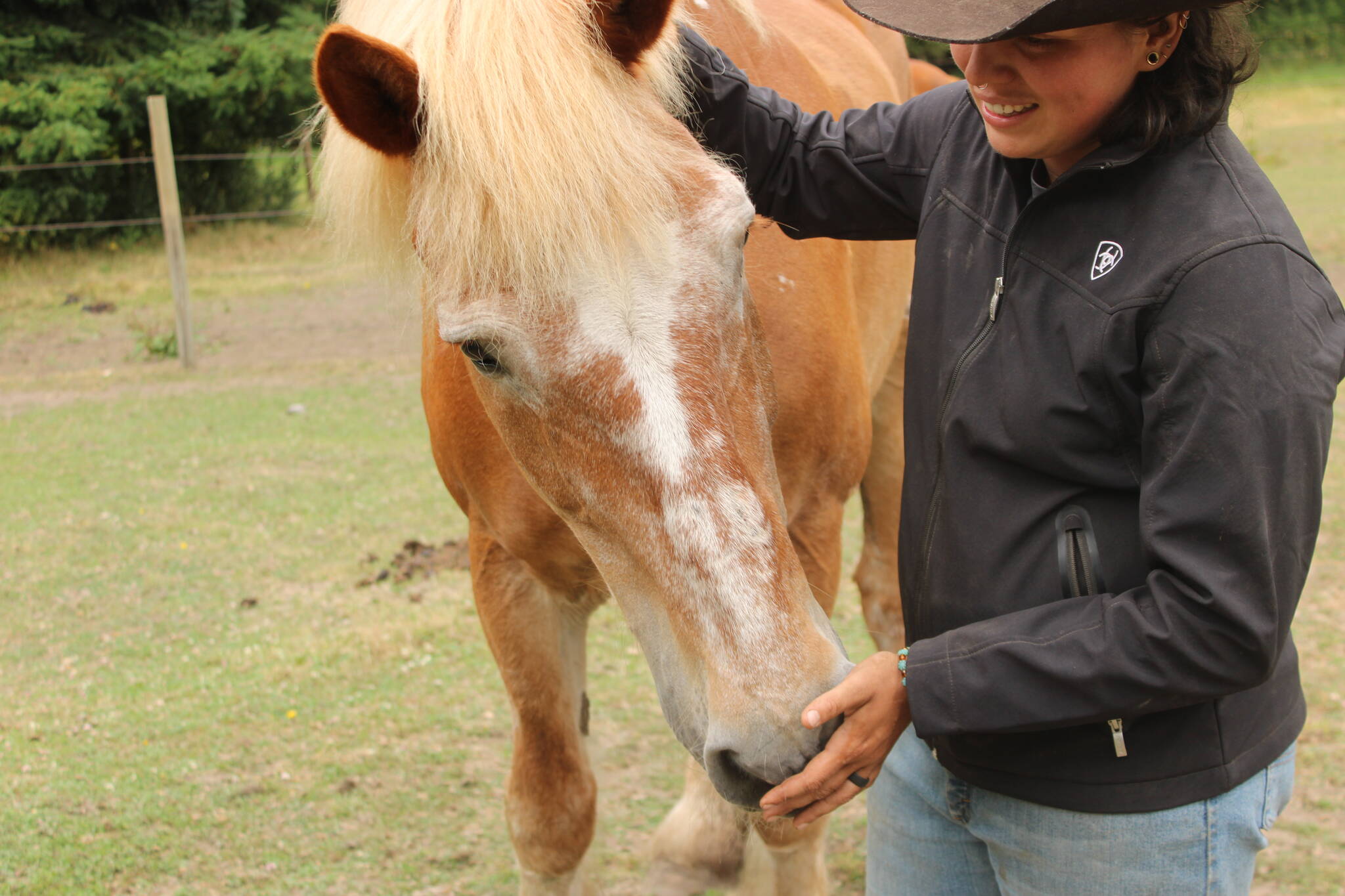 Rhed pets Joel, one of many horses at Big Rhed Barn (Photo by Allyson Ballard)