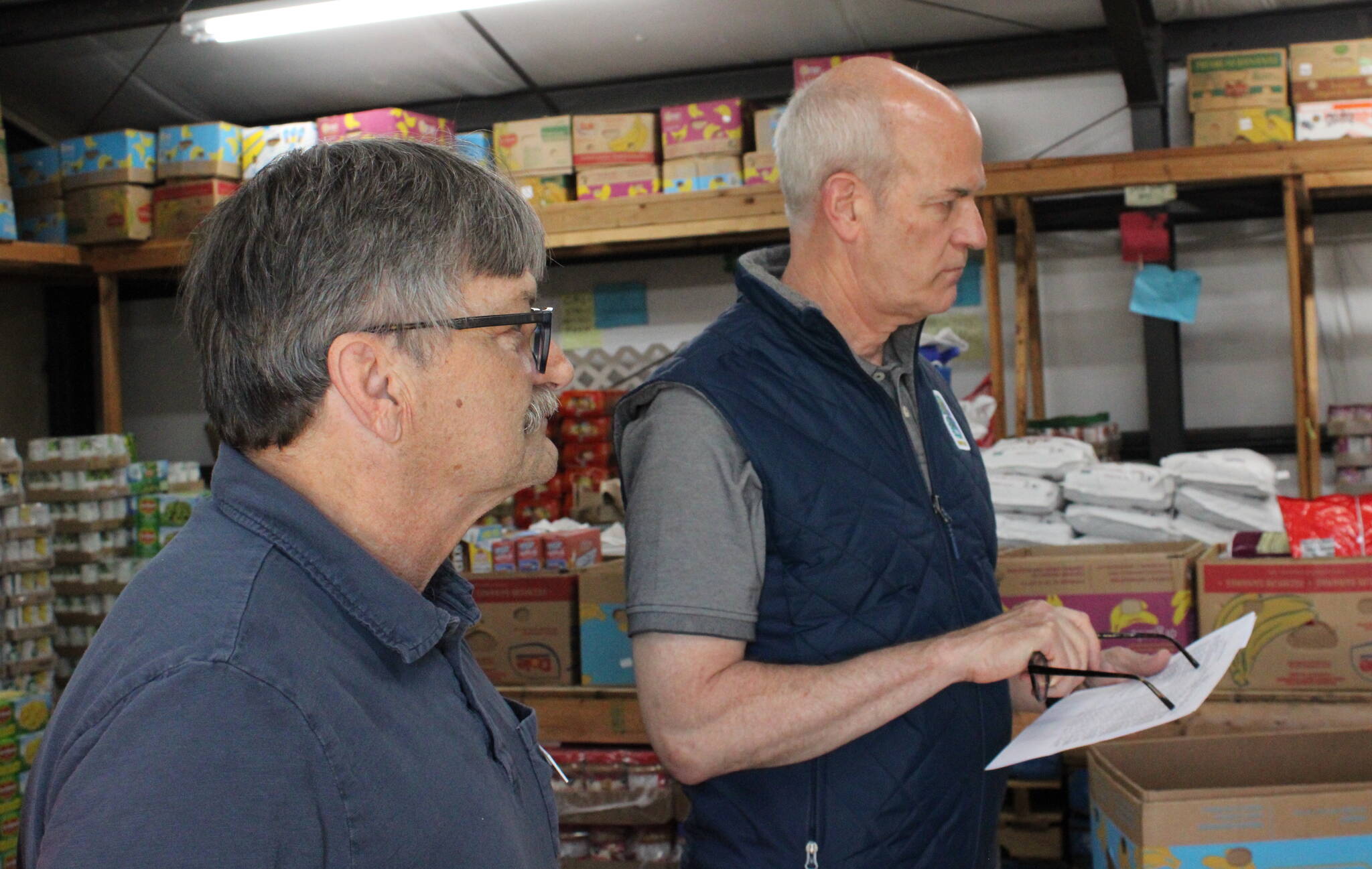 Shawn Durbin, the deputy director of North Whidbey Help House, shows U.S. Rep Rick Larsen around the food bank (Photo by Allyson Ballard)