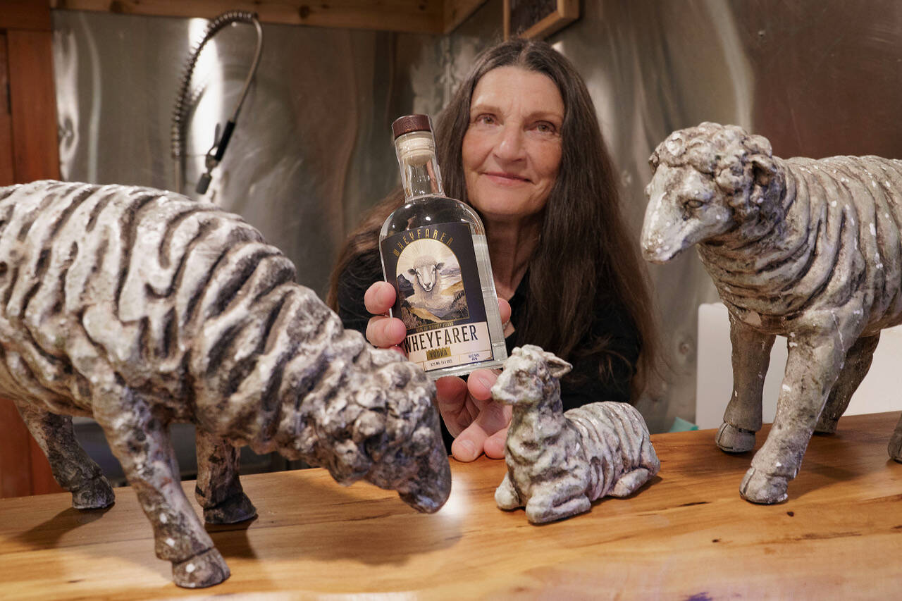 (Photo by David Welton) Lynn Swanson displays a bottle of the new Wheyfarer Vodka.