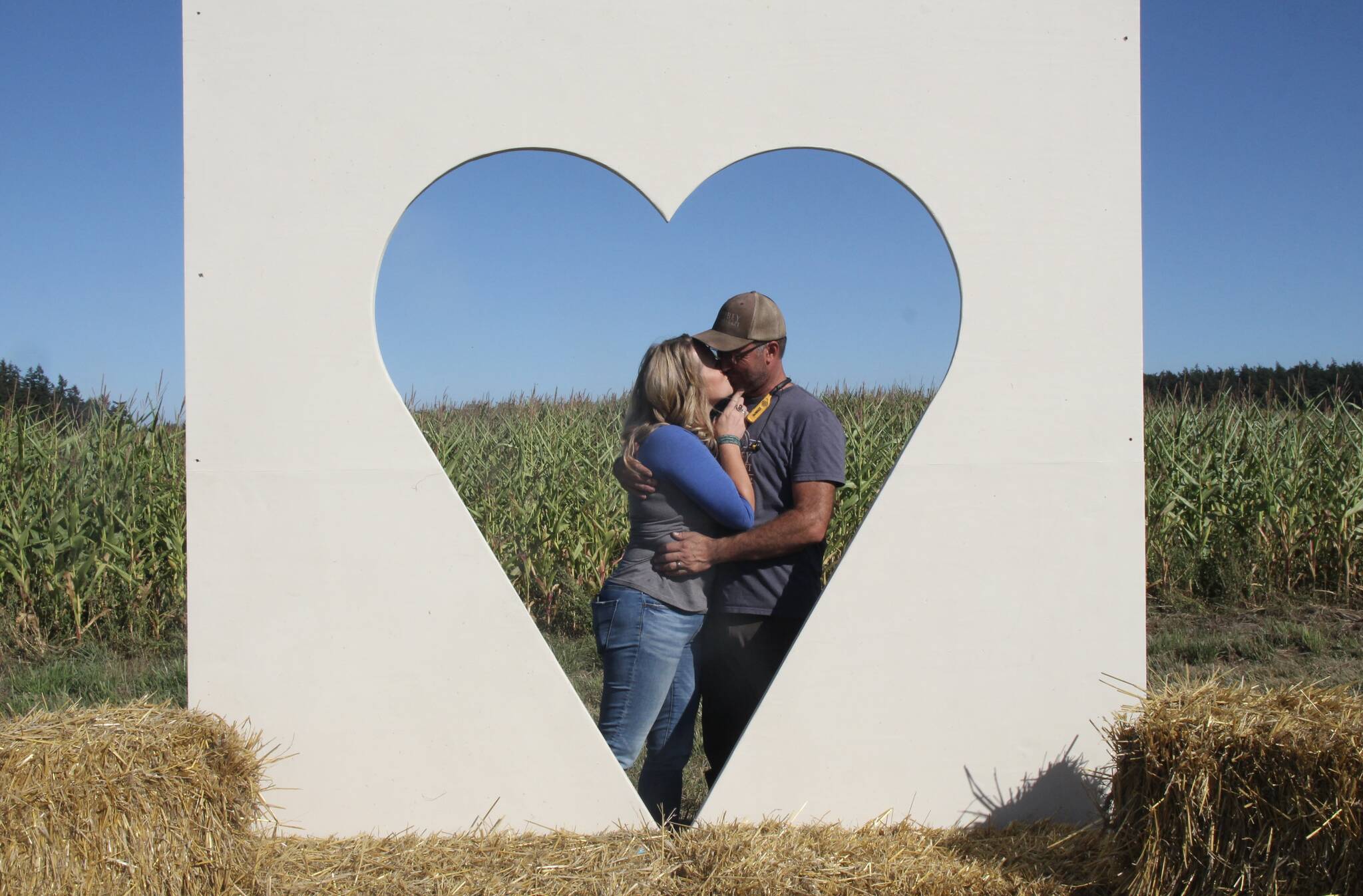 (Photo by Marina Blatt) Shannon and Steve Hilborn kiss behind a cut-out heart.