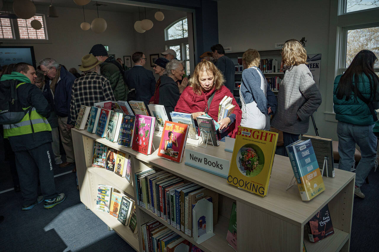 (Photo by David Welton) Patrons peruse the collection at the newly renovated Langley Library during a reopening ceremony earlier this year.