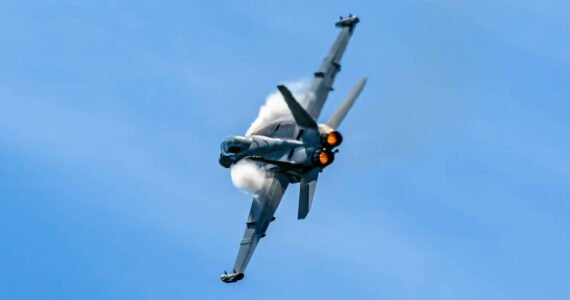 Photo by Joe A. Kunzler
Vapor forms of an EA-18G Growler as it streaks through blue skies.