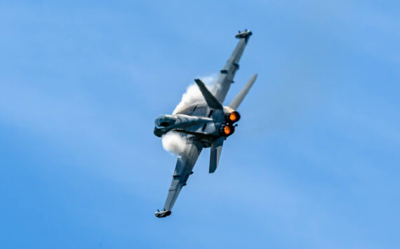 Photo by Joe A. Kunzler
Vapor forms of an EA-18G Growler as it streaks through blue skies.