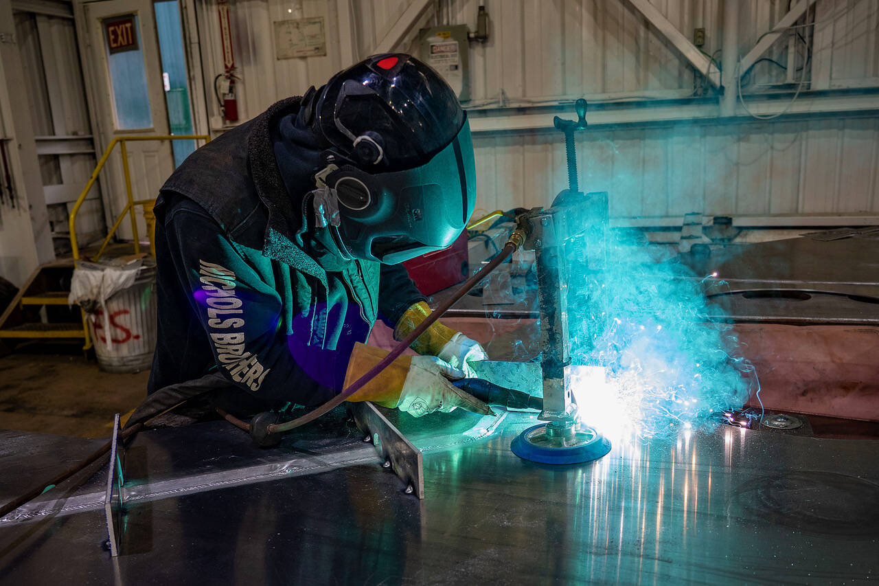(Photo by David Welton) A welder recently works on part of a hull at Nichols Brothers Boat Builders in Freeland. The longtime company is hoping to double its production staff by the middle of next year.