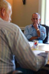 Port of South Whidbey Commissioner Curt Gordon listens to a report on unplanned marina project expenses.