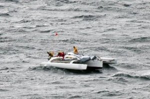 Boaters aboard a demasted catamaran drift near Cultus Bay on Saturday after high winds disabled their vessel.