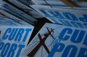 Signs from this year’s election  are stacked outside Curt Gordon’s asphalt business in Clinton. Gordon won election this November to the Port of South Whidbey board.