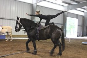 Vaulting team member Kyrsten Tabada demonstrates a compulsory vaulting move on the back of a 16-year-old Kirbey.