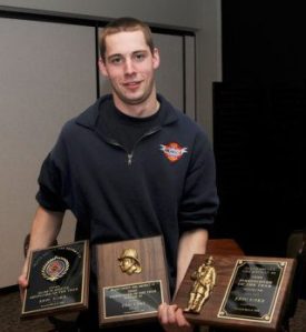Eric Unke shows off his awards he received at the annual Island County Fire District 3 banquet at Useless Bay Country Club.