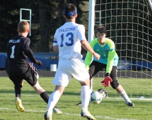 Falcon junior goalie Charlie Stelling bends down to stop a shot by Archbishop Murphy in the first half on Friday