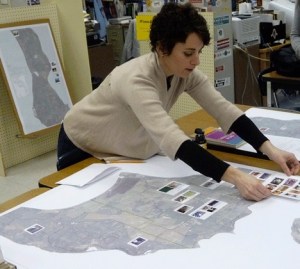 Aimie Vallat organizes the photographs of local farms taken by eighth-grade students at Coupeville Middle School for a food-asset mapping project.