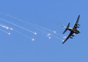 An EA-6B Prowler assigned to the 'Lancers' of VAQ-131 deploys emergency flares during an air power demonstration for the crew of the aircraft carrier USS Abraham Lincoln during the squadron's deployment.