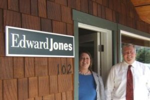 Kristi Kammenga and Don Rowan stand in the doorway of their new financial services office in Clinton.