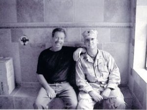 Robert Rorex sits with his son