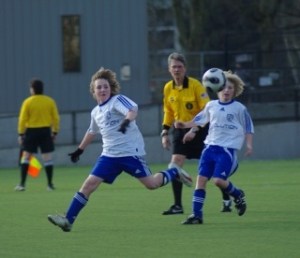 Revolution U-12 soccer players Donald Gambill and Kameron Donohoe fire the ball to a teammate Saturday during their 2-0 victory in the Commissioner’s Cup semi-final game in Tukwila.