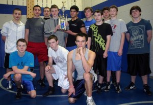 The Falcon varsity wrestling team hoists its second-place trophy won at the Chief Sealth wrestling tournament on Dec. 28.